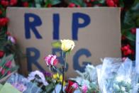 Flowers and tributes are seen as people gather in front of the U.S. Supreme Court following the death of U.S. Supreme Court Justice Ruth Bader Ginsburg, in Washington