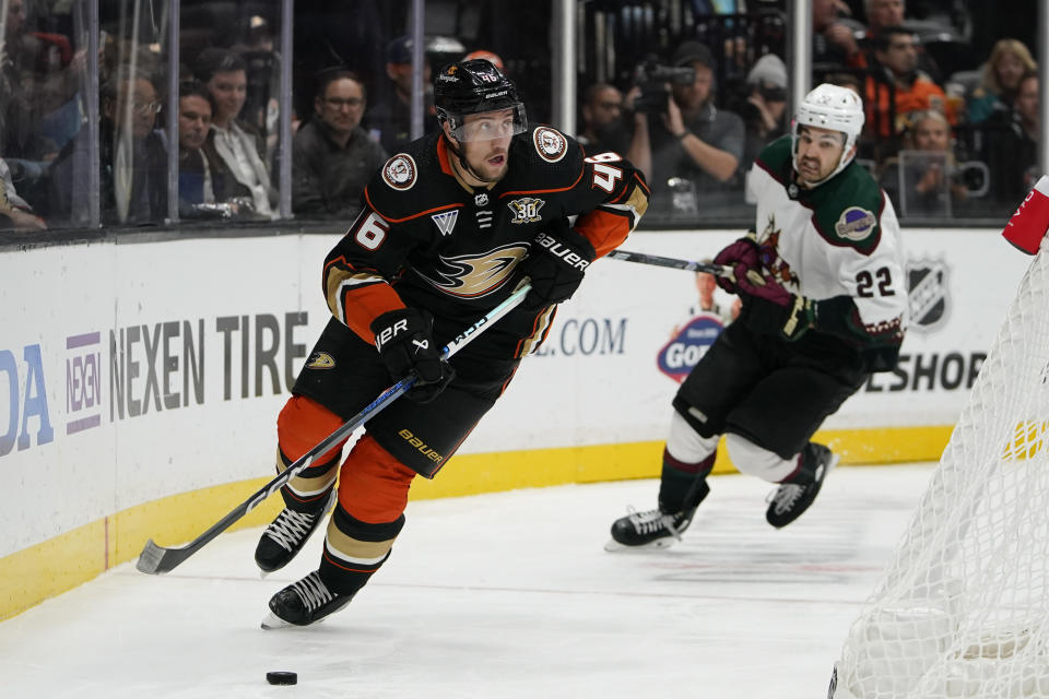 Anaheim Ducks defenseman Ilya Lyubushkin, left, controls the puck as Arizona Coyotes center Jack McBain chases during the second period of an NHL hockey game Wednesday, Nov. 1, 2023, in Anaheim, Calif. (AP Photo/Ryan Sun)