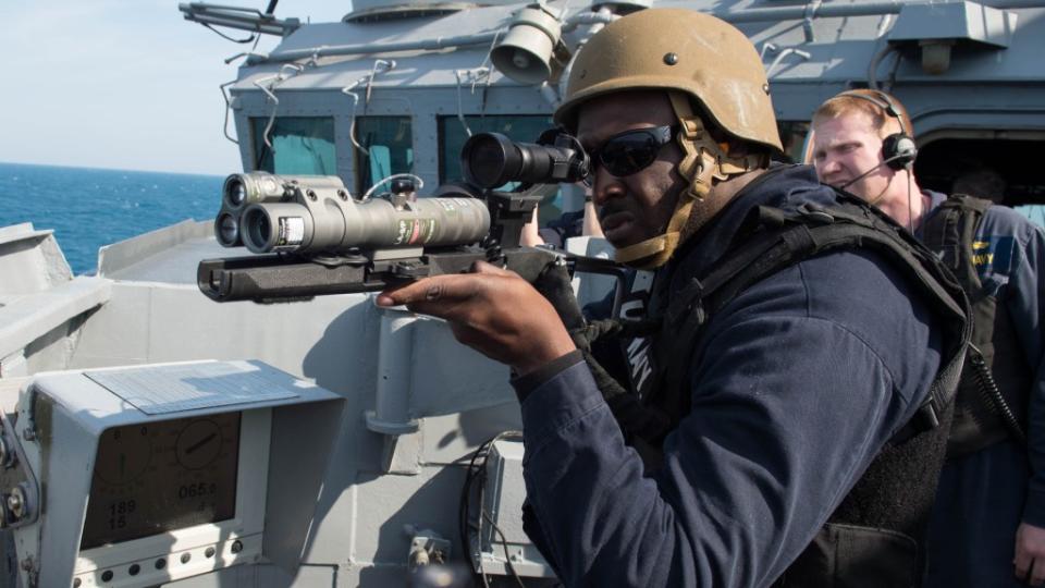 A US Navy sailor aims an LA-9/P, an example of a laser dazzler already in US military service. <em>USN</em>