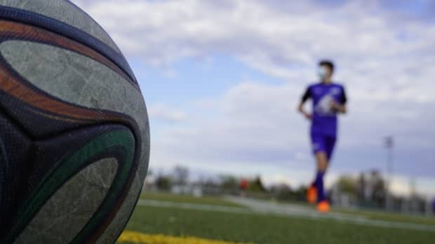 A young man wears a mask while on a soccer pitch in Gatineau, Que., on April 15, 2021.