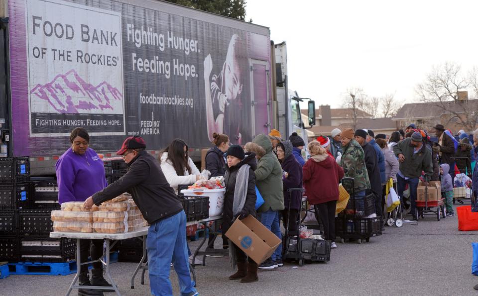 Clients of the Food Bank of the Rockies line up to collect food distribution in Denver on Dec. 19, 2019.