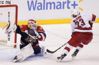 Florida Panthers goaltender Sergei Bobrovsky (72) stops a shot on goal by Carolina Hurricanes left wing Brock McGinn (23) during the second period at an NHL hockey game, Saturday, Feb. 27, 2021, in Sunrise, Fla. (AP Photo/Marta Lavandier)