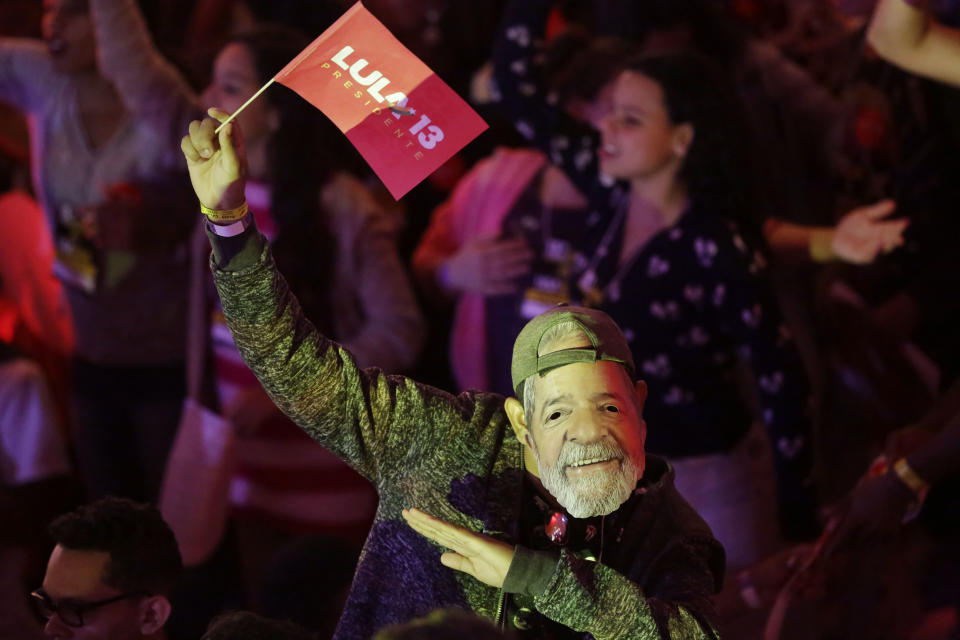 A man wears a mask depicting the Brazil's former President Luiz Inacio Lula da Silva during a Workers Party national convention in Sao Paulo, Brazil, Saturday, Aug. 4, 2018. The convention confirmed the jailed Lula da Silva as their candidate for the country's presidency in October's election. Da Silva leads the polls by a large margins, but is likely to be barred by Brazil's electoral justice. (AP Photo/Nelson Antoine)
