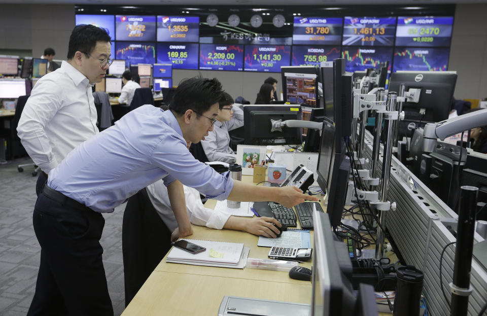 Currency traders watch monitors at the foreign exchange dealing room of the KEB Hana Bank headquarters in Seoul, South Korea, Wednesday, April 10, 2019. Asian shares fell Wednesday following a slide on Wall Street amid growing tensions between the U.S. and the European Union and a dim forecast on global economic growth. (AP Photo/Ahn Young-joon)