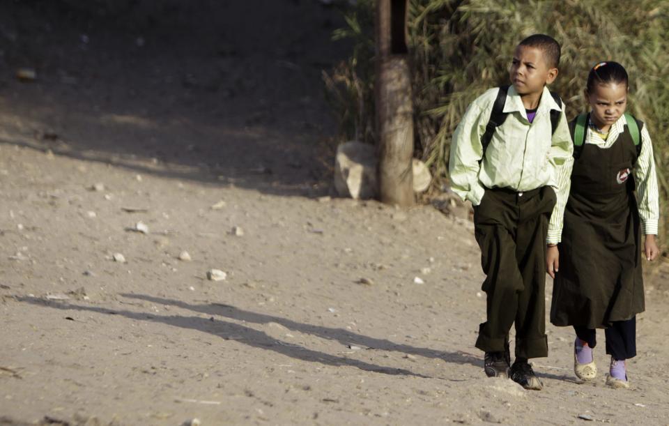 Students walk to school on the first day of their new school year in Giza