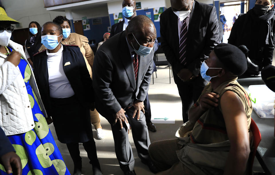 South African President Cyril Ramaphosa greets patients as he visits a COVID-19 vaccination centre in Tembisa, Thursday, July 29, 2021. Hitting its stride after a faltering start, South Africa’s mass vaccination campaign gave jabs to 220,000 people a day last week and is accelerating toward the goal of 300,000 per day. With large deliveries of doses arriving and some vaccines being assembled here, South Africa appears on track to inoculate about 35 million of its 60 million people by the end of the year. (AP Photo)