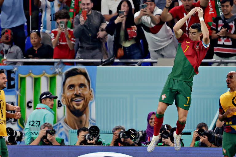 DOHA, QATAR - NOVEMBER 24: Cristiano Ronaldo of Portugal celebrates 1-0, banner of Lionel Messi in the background during the  World Cup match between Portugal  v Ghana at the Stadium 974 on November 24, 2022 in Doha Qatar (Photo by Eric Verhoeven/Soccrates/Getty Images)