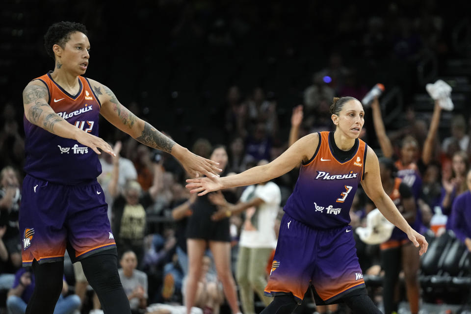 FILE - Phoenix Mercury center Brittney Griner, left, celebrates a score by guard Diana Taurasi (3) during the second half of the team's WNBA basketball game against the Minnesota Lynx on Thursday, May 25, 2023, in Phoenix. Five-time Olympic gold medalist Diana Taurasi and Brittney Griner head up the USA Basketball Women’s National Team roster of 16 players announced Thursday, Oct. 26, 2023, for a pair of November exhibition games and training camp in Atlanta. (AP Photo/Ross D. Franklin, File)