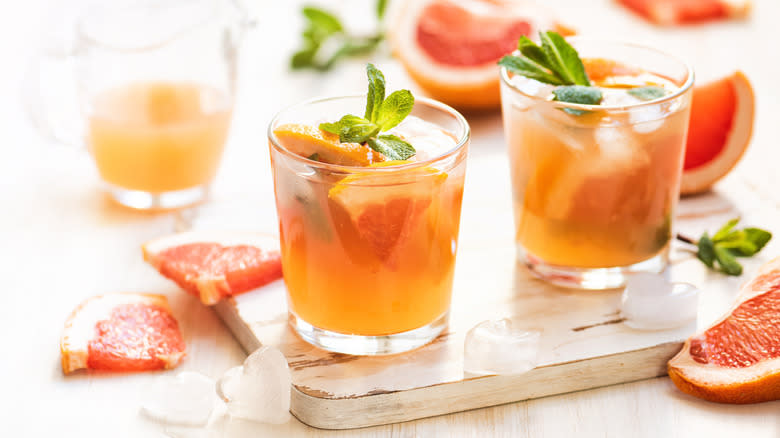 two grapefruit cocktails with mint