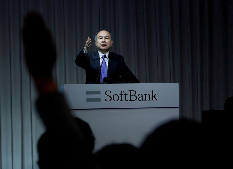 FILE PHOTO: A journalist raises her hand to ask a question to Japan's SoftBank Group Corp Chief Executive Masayoshi Son during a news conference in Tokyo