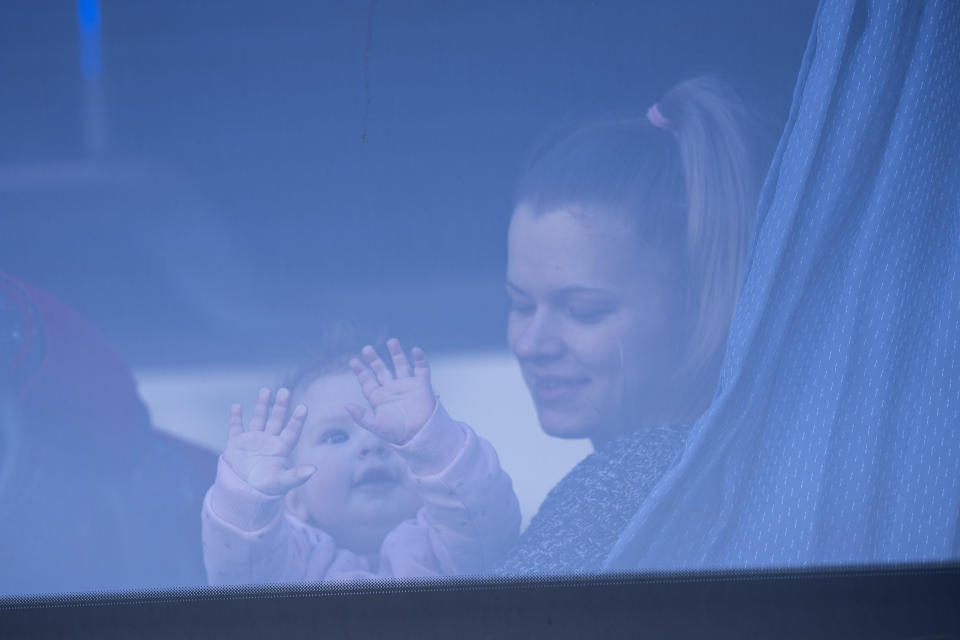 A Ukrainian woman and her child who fled the war in Ukraine wait in a bus after arriving to Przemysl train station in Przemysl, Poland, Tuesday, March 15, 2022. (AP Photo/Petros Giannakouris)