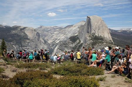 Tourists wait at Glacier Point as U.S. President Barack Obama and his family hike in the area at Yosemite National Park, California, U.S., June 18, 2016. REUTERS/Joshua Roberts