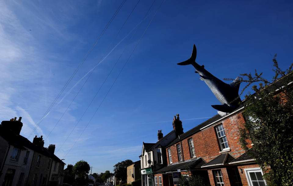 The fibreglass sculpture 'Untitled 1986', but more commonly named 'The Headington Shark', which has been on display since 1986, is seen embedded in the roof of a house in a street in Oxford, Britain, May 14, 2019. REUTERS/Toby Melville