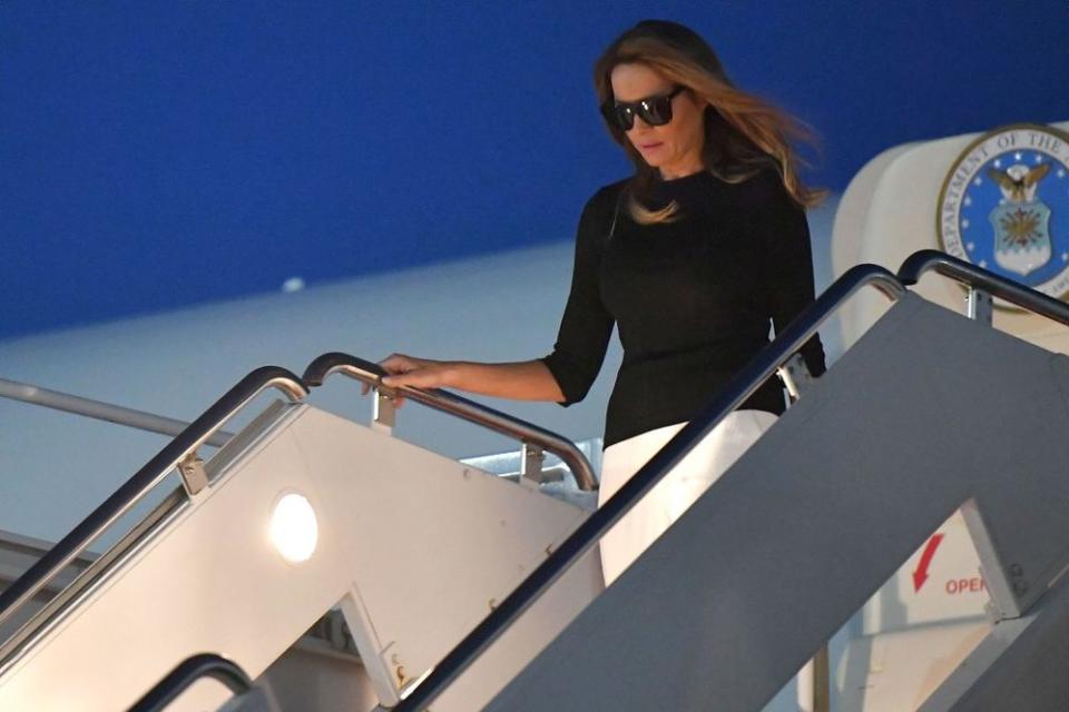 Melania Trump deplanes an aircraft after smoke and a burning smell were detected