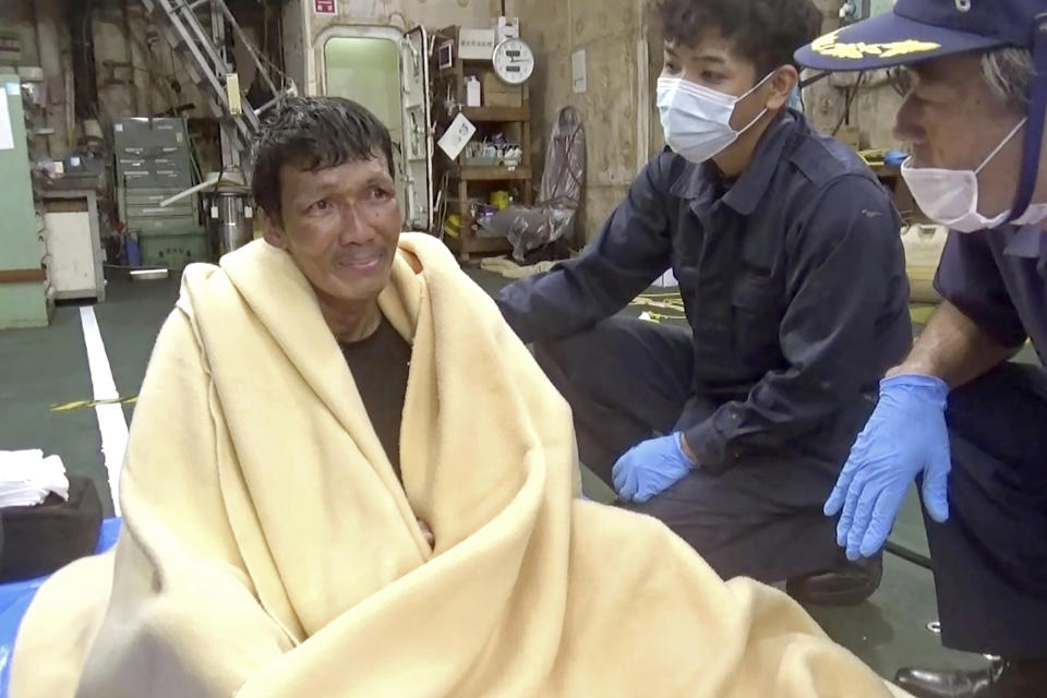 In this image made from video that was released by the 10th Regional Japan Coast Guard Headquarters, a rescued crew member of a Panamanian cargo ship speaks to Japanese Coast Guard members off the Amami Oshima, Japan Wednesday, Sept. 2, 2020. Japanese rescuers have safely plucked the crew member from the sea while searching for the cargo ship carrying more than 40 crew and thousands of cows went missing after sending a distress call off the southern Japanese island. (The 10th Regional Japan Coast Guard Headquarters via AP)