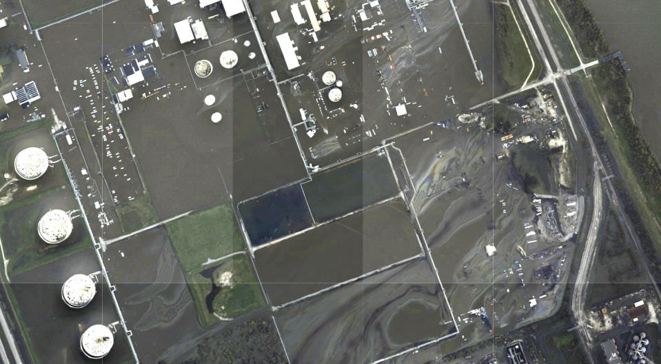 This image provided by NOAA taken Tuesday, Aug. 31, 2021 and reviewed by The Associated Press shows oil slicks at the flooded Phillips 66 Alliance Refinery in Belle Chasse, La. State and federal regulators responded to the spill site after AP provided the photos of the spill Wednesday and the company acknowledged a "sheen of unknown origin" at its flooded refinery. (NOAA via AP)