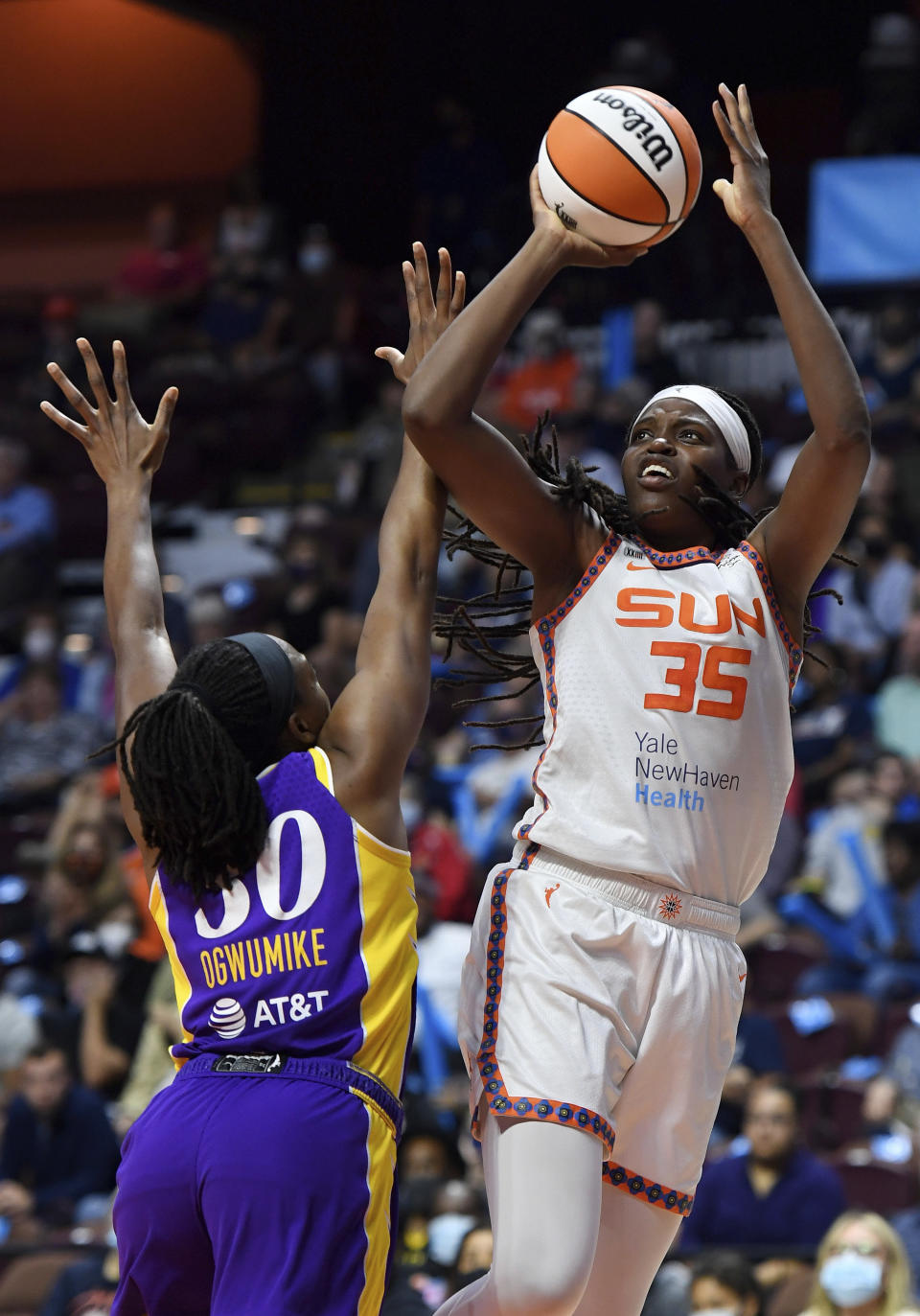 FILE - Connecticut Sun forward Jonquel Jones (35) shoots over Los Angeles Sparks forward Nneka Ogwumike (30) during a WNBA basketball game in Uncasville, Conn., in this Saturday, Aug. 28, 2021, file photo. This year, the 6-foot-6 Jones is the unanimous choice AP Player of the Year honors by the 14-member panel, announced Wednesday, Sept. 22, 2021. (Sean D. Elliot/The Day via AP, File)