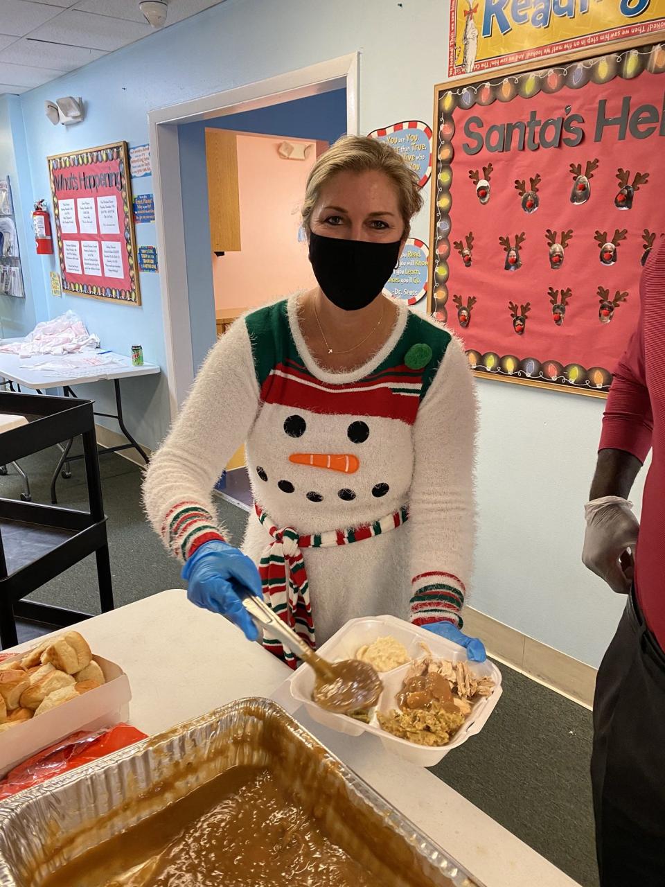 Stacey Heatherington, commissioner of Martin County  volunteered to help serve Thanksgiving dinner to guests.