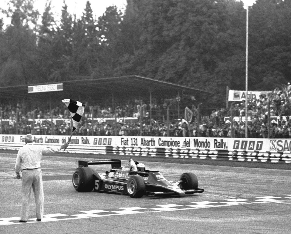 FILE - Mario Andretti gets the checkered flag as he crosses the finish line in the Italian Grand Prix at Monza, Italy, Sept. 10, 1978. American Michael Andretti cleared a major hurdle in his bid to launch a Formula One team as the FIA said Monday, Oct. 2, 2023, that he meets all required criteria to expand the world's top motorsports series to 11 teams. The father and son are among the most successful racers in American open wheel history and rank third and fourth on IndyCar's all-time win list. (AP Photo/File)