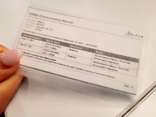 A printed copy of an individual's Alberta COVID-19 immunization record.  (Sarah Rieger/CBC - image credit)