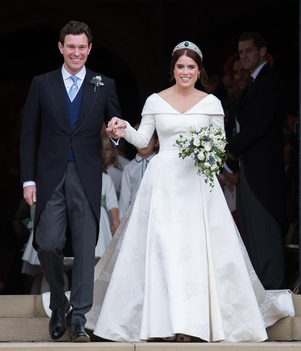  Princess Eugenie of York and Jack Brooksbank leave St George's Chapel in Windsor Castle following their wedding at St. George's Chapel on October 12, 2018 in Windsor, England. 