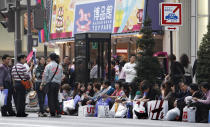 FILE - Chinese tourists take a break after shopping in Tokyo's posh Ginza district on April 11, 2010. The Japan-China Exchange Festival in Tokyo, after a two-year hiatus due to the COVID-19 pandemic, was back last weekend ahead of this week’s 50th anniversary of the normalizing of relations between the two Asian neighbors and economic powerhouses. (AP Photo/Shizuo Kambayashi, File)