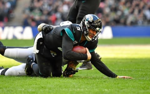 Jacksonville Jaguars quarterback Blake Bortles (5) is sacked by Philadelphia Eagles defensive end Chris Long (56) during the second quarter of an NFL International Series game at Wembley Stadium - Credit: Steve Flynn/USA Today