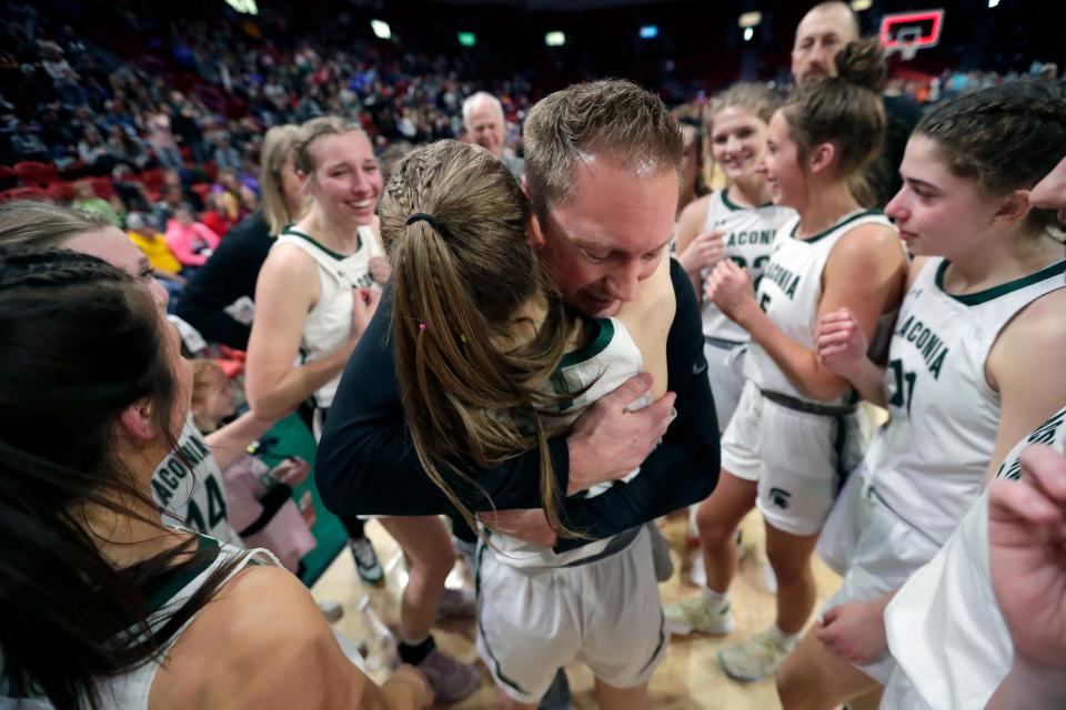 Laconia head coach Chris Morgan hugs senior Reece Keel after the Spartans defeated Aquinas High School in the WIAA Division 4 girls basketball championship game March 11 at the Resch Center in Ashwaubenon.
