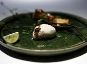 A grilled pufferfish testicle, cooked by Yoshihiro Narisawa, the owner and chef of Tokyo's French restaurant Narisawa, is seen on a plate at Narisawa in Tokyo March 26, 2015. REUTERS/Yuya Shino