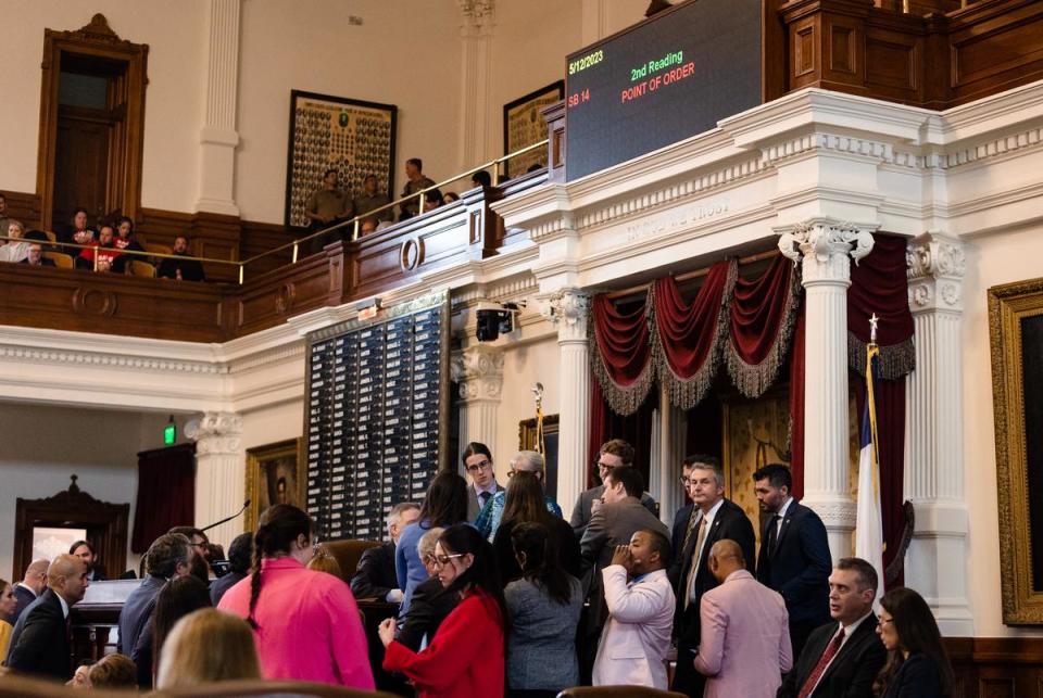 State representatives gather to listen to discussion of a Point of Order brought against SB 14 on the House floor at the state Capitol in Austin on May 12, 2023.
