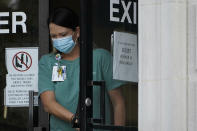 An individual wearing a face mask exits the Ouachita Parish Courthouse in Monroe, La., Thursday, Aug. 5, 2021. Signage at this and other parish offices emphasizes the necessity of wearing a face mask as Louisiana is reinstating a statewide mask mandate for both vaccinated and unvaccinated residents in all indoor locations, including schools and colleges as the state experiences the highest per capita COVID-19 growth in the nation, driven by the Delta variant and one of the country's lowest vaccination rates. (AP Photo/Rogelio V. Solis)