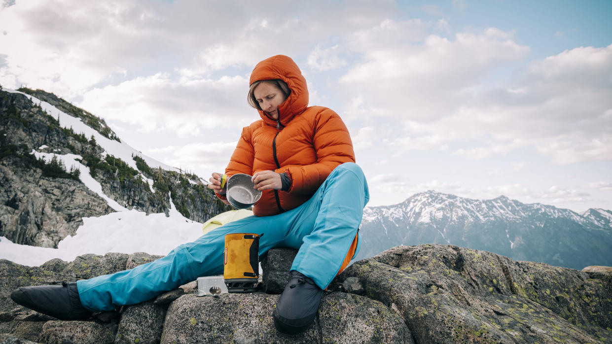  how to clean a hiking stove: hiker cleaning cooking equipment and stove 