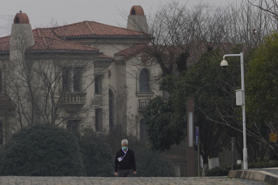 Dominic Dwyer of a World Health Organization team walks in the cordoned hotel area in Wuhan in central China's Hubei province on Thursday, Feb. 4, 2021. The WHO team is investigating the origins of the coronavirus pandemic in the province. (AP Photo/Ng Han Guan)