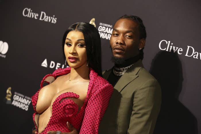 The couple posing on the red carpet of a Grammy Awards event