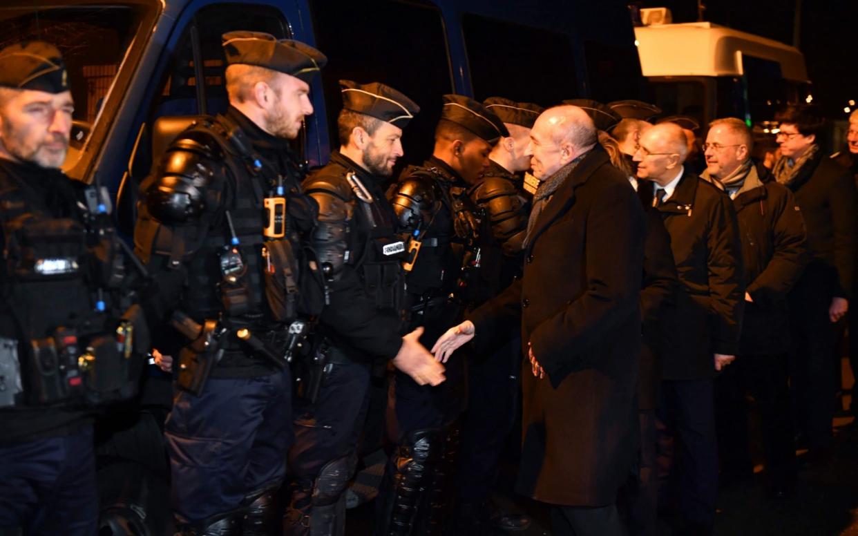 French Interior Minister Gerard Collomb (C) meets in Calais, northern France, following a large brawl between a hundred migrants which resulted in several injuries. - AFP