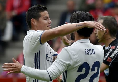 Football Soccer- Spanish La Liga Santander - Sporting v Real Madrid - El Molinon Stadium, GIjon, Spain - 15/04/17 Real Madrid's Francisco "Isco" Alarcon (R) is congratulated by team mate James Rodriguez after scoring a goal. REUTERS/Eloy Alonso