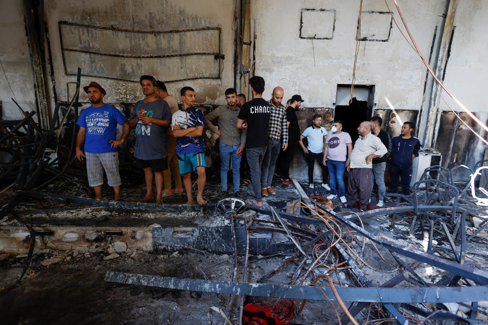 People gather at the site following a fatal fire at a wedding celebration, in the district of Hamdaniya, in Iraq's Nineveh province, Sept. 27, 2023. / Credit: KHALID AL-MOUSILY/REUTERS