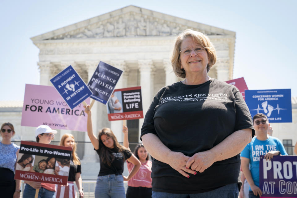 Tanya Ditty, 62, of Alexandria, Va., poses for a portrait while protesting with the group, Concerned Women for America, outside the Supreme Court in opposition to abortion, Wednesday, June 15, 2022, in Washington. "This is a historic moment for my generation," says Ditty. She recalls being a teenager when Roe V. Wade was passed. "We will continue to go to those statehouses, year after year, and attempt and attempt and attempt." (AP Photo/Jacquelyn Martin)