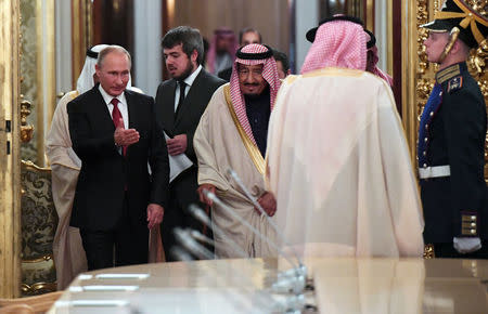 Russian President Vladimir Putin shows the way to Saudi Arabia's King Salman during a meeting at the Kremlin in Moscow, Russia, October 5, 2017. REUTERS/Yuri Kadobnov/Pool