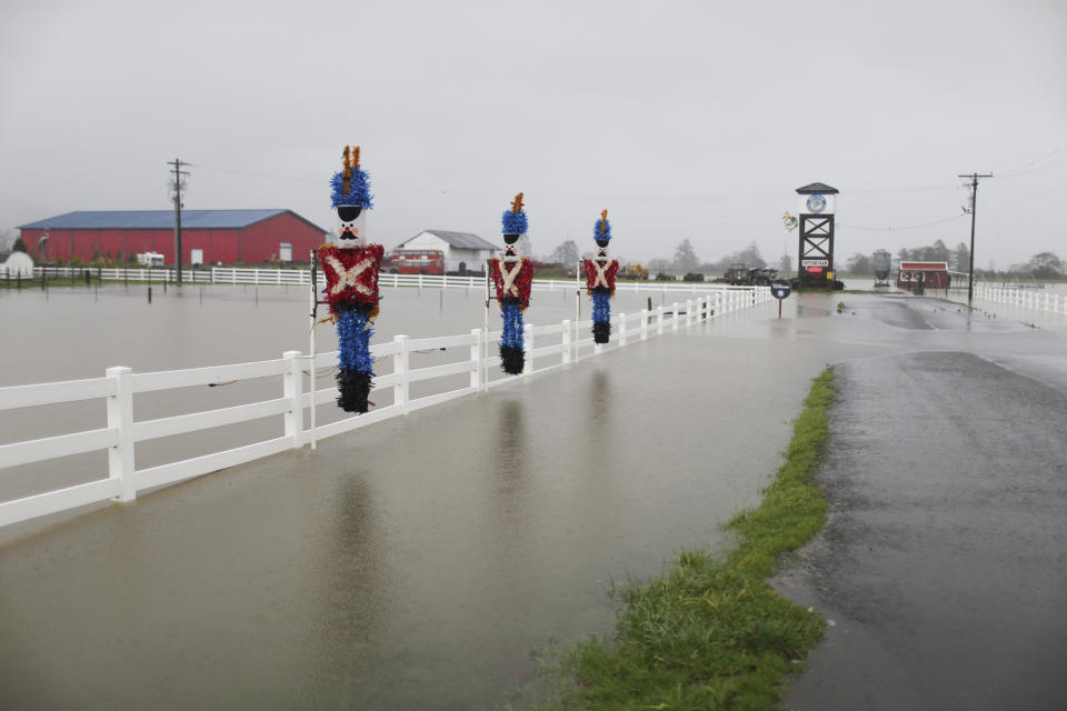 Heavy rain causes flooding outside Blue Heron French Cheese Company along Highway 101 in Tillamook, Ore., Tuesday, Dec. 5, 2023. (Dave Killen/The Oregonian via AP)