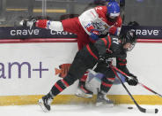 Czechia's Aneta Tejralova (2) and Canada's Ella Shelton (17) battle for the puck during the first period of a semifinal at the women's world hockey championships in Utica, N.Y., Saturday, April 13, 2024. (Christinne Muschi/The Canadian Press via AP)