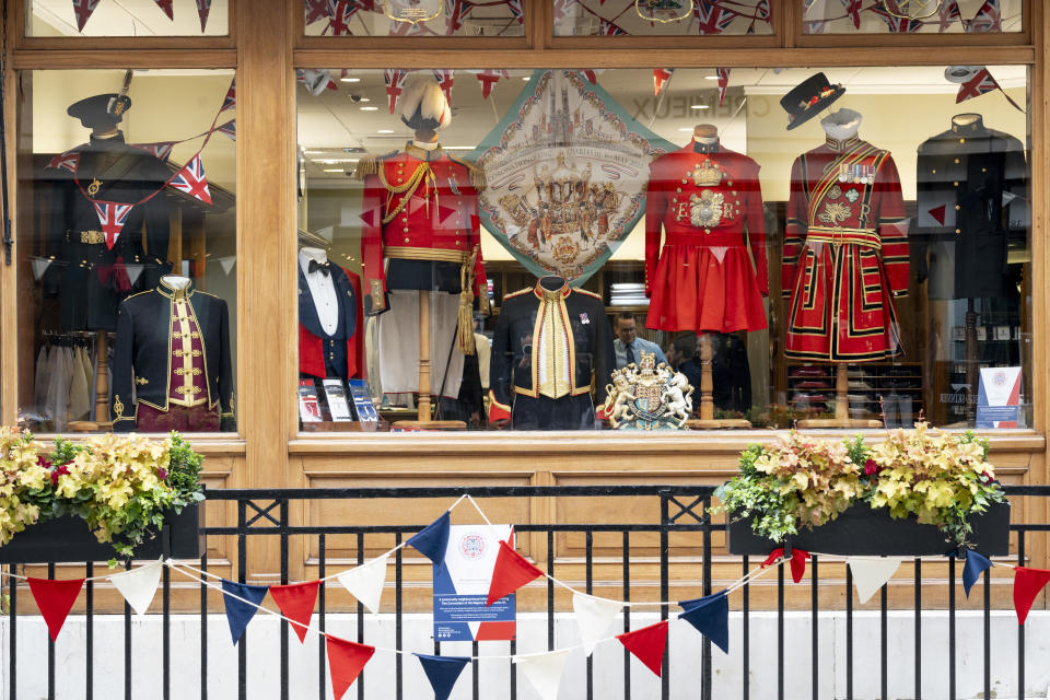 Military ceremonial uniforms are displayed in the window of Dege & Skinner in Savile Row, with ceremonial bunting hanging in front of the shop. Founded in 1865, it is one of the oldest, continually operated bespoke tailoring companies in the world.