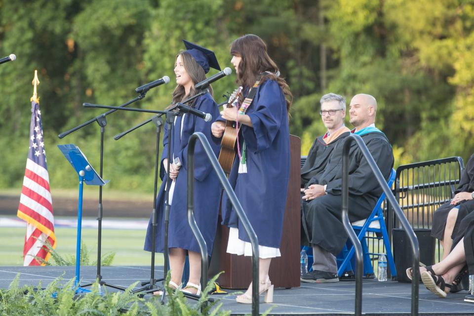 Casside Bowedn and Gracie Todd, graduates of West Henderson's 2023 Class, sing "The Climb" to their classmates and the large showing of family, friends, and supporters Friday evening at West's Commencement Ceremony. [PAT SHRADER/ SPECIAL TO THE TIMES-NEWS]