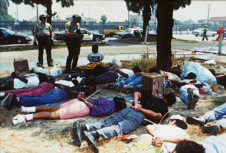 Police standing over suspects