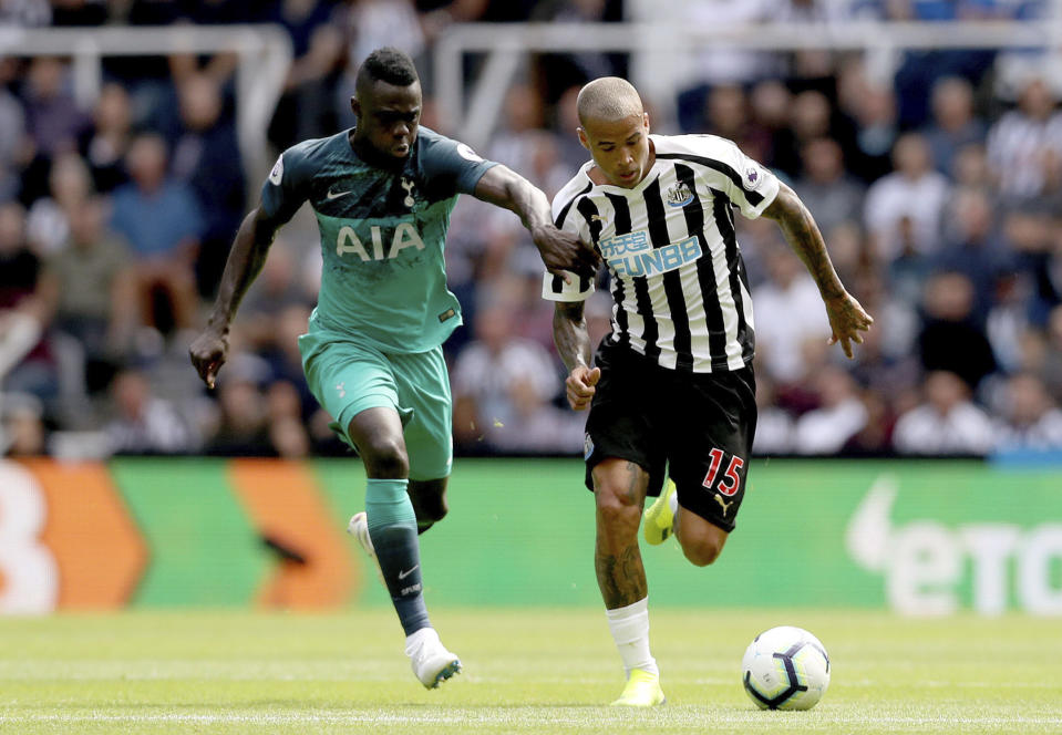 Newcastle United's Kenedy, right, and Tottenham Hotspur's Davinson Sanchez run for the ball during their English Premier League soccer match at St James' Park in Newcastle, England, Saturday Aug. 11, 2018. (Owen Humphreys/PA via AP)