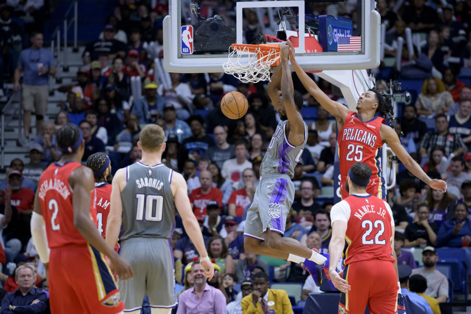 Sacramento Kings forward Harrison Barnes (40) dunks against New Orleans Pelicans guard Trey Murphy III (25) during the first half of an NBA basketball game in New Orleans, Tuesday, April 4, 2023. (AP Photo/Matthew Hinton)