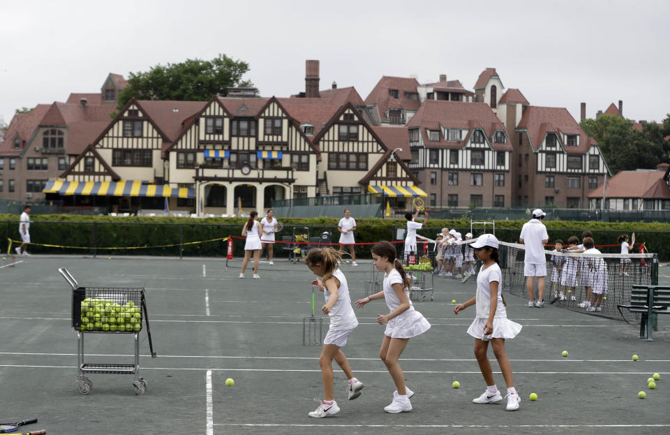 In this Tuesday, July 2, 2013 photo, kids participate in drills at the West Side Tennis Club in the Queens section of New York. The Beatles. The Rolling Stones. Frank Sinatra. Jimi Hendrix. Bob Dylan. They’ve all held court at the more than century-old West Side Tennis Club in Queens’ Forest Hills neighborhood - for six decades the site of the U.S. Open Tennis Championships. Plans are now in the works for the grassy lawn to come alive again with the sound of music, starting with a concert featuring the British band Mumford & Sons, to be followed by a lineup of world-class musicians. (AP Photo/Seth Wenig)