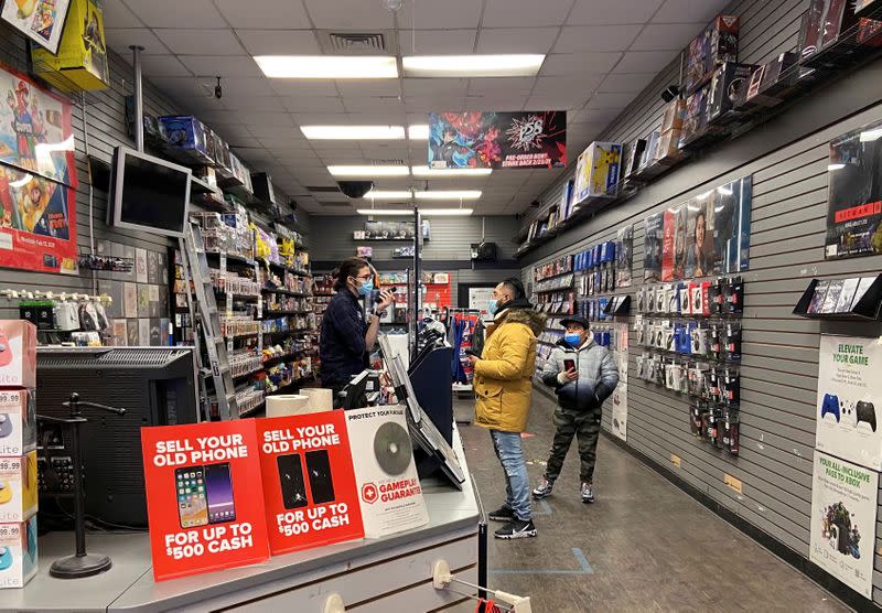 FILE PHOTO: An employee talks with a customer at a GameStop shop in New York City