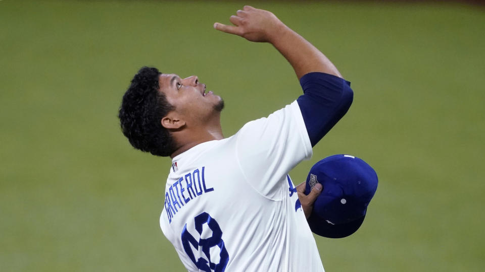 Los Angeles Dodgers relief pitcher Brusdar Graterol (48) celebrates after a catch by Cody Bellinger ending the top of the seventh inning in Game 2 of a baseball National League Division Series Wednesday, Oct. 7, 2020, in Arlington, Texas. (AP Photo/Tony Gutierrez)