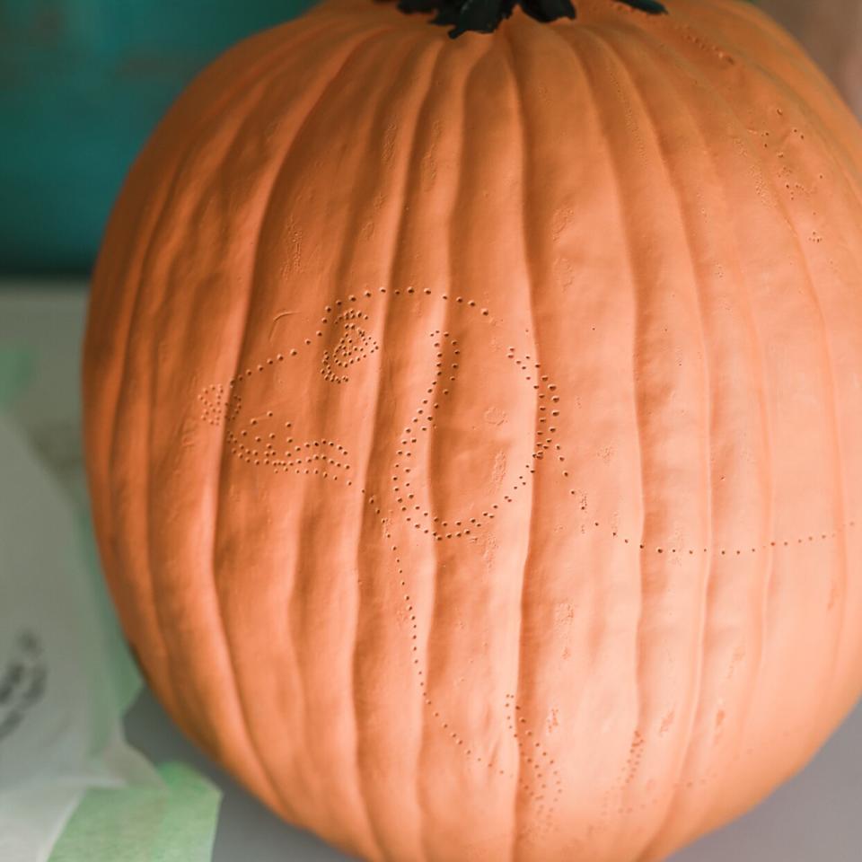 pumpkin carving with pin points in the shape of a dog